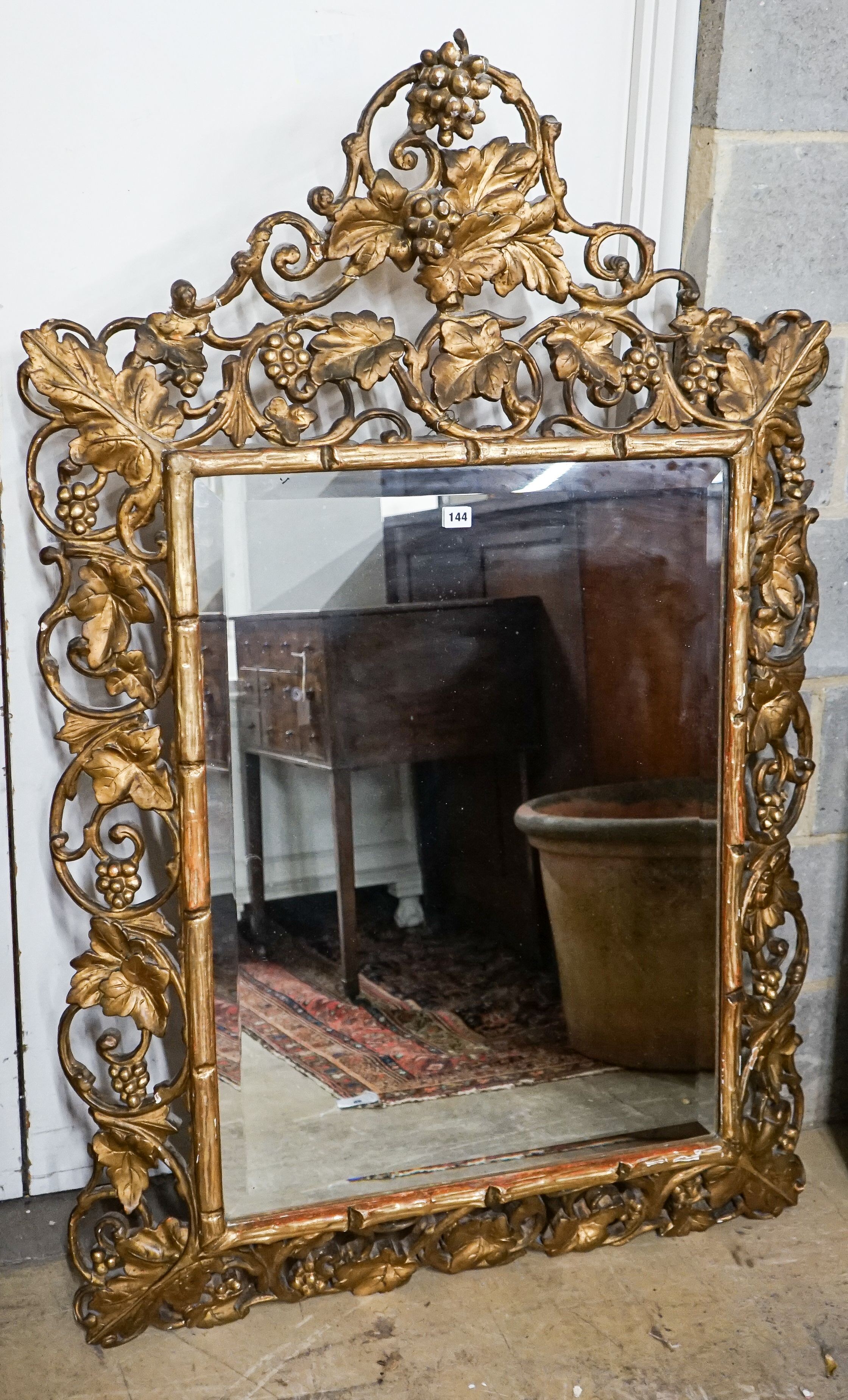 A Victorian carved giltwood and gesso rectangular wall mirror with pierced fruiting vine border, width 98cm, height 148cm